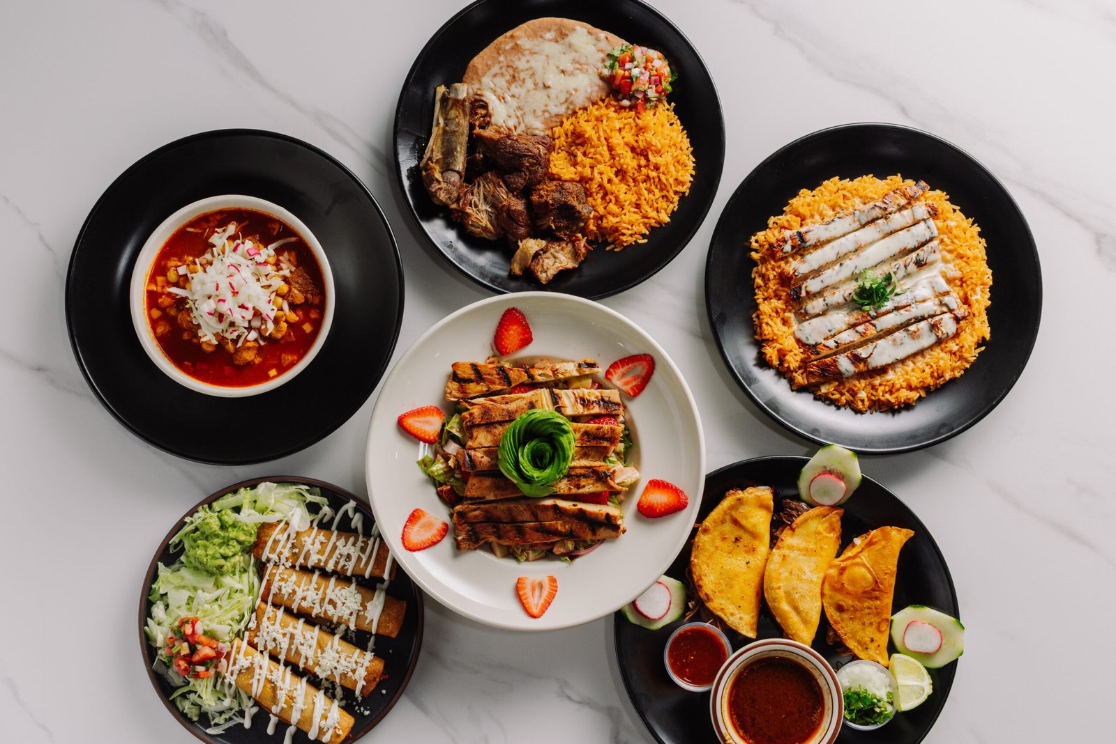 A table filled with assorted Mexican dishes